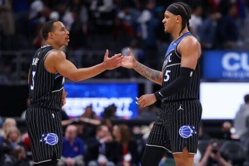 Desmond Bane, left, scored 22 points and Paolo Banchero, right, added 18 for the Orlando Magic in an NBA playoff victory over Detroit